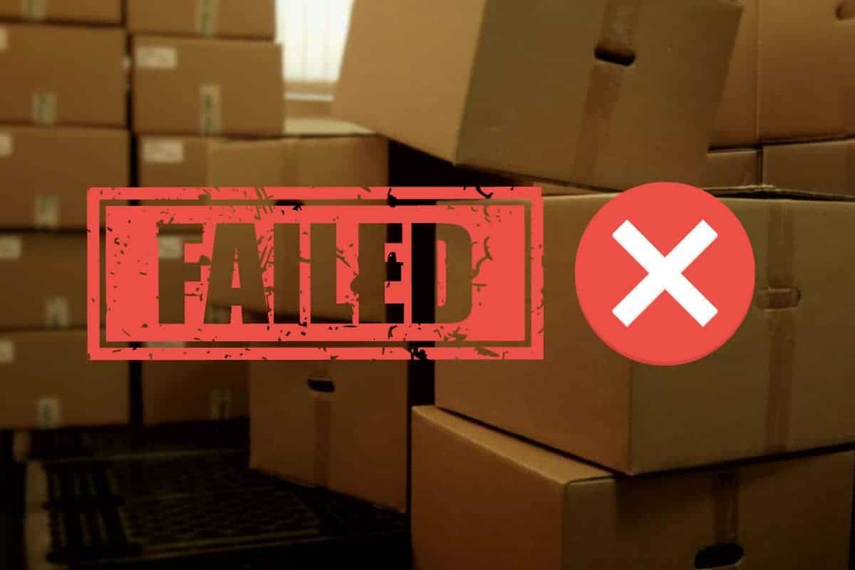 the word "failed" in the foreground with piles of brown boxes in the background